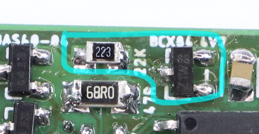 Excerpt from the photograph of the circuit board. A small piece with three pins highlighted together with a resistor.