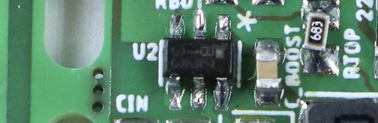 Another excerpt from the photo, focusing on a small chip with six pins.